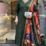 Women wearing dark green embroidered kurta pant set with printed dupatta